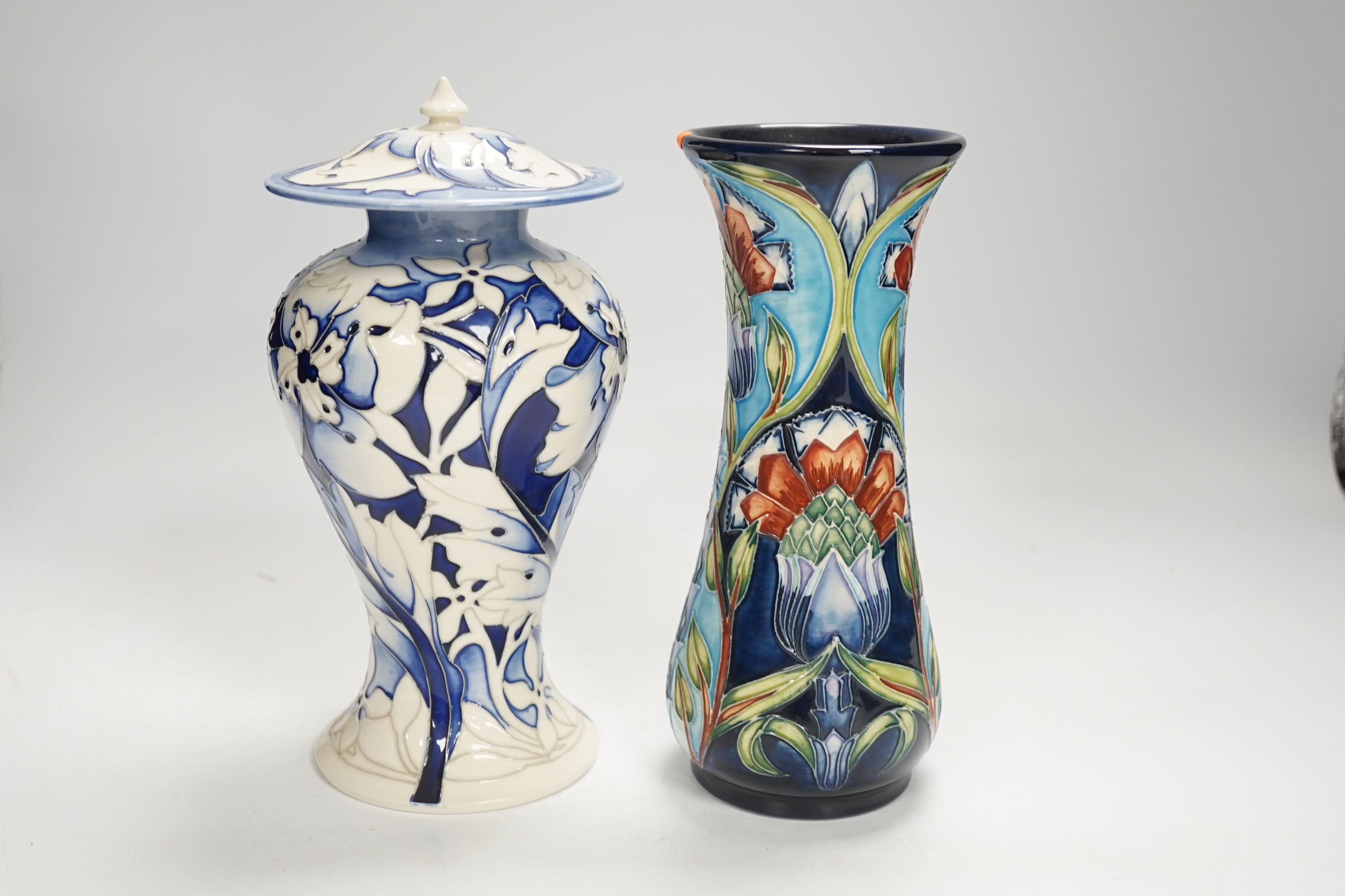 A Moorcroft floral vase designed by Shirley Hayes, limited edition 27/30 and a Moorcroft blue and white jar and cover by Emma Bossons, limited edition 2/3, largest 23cm high